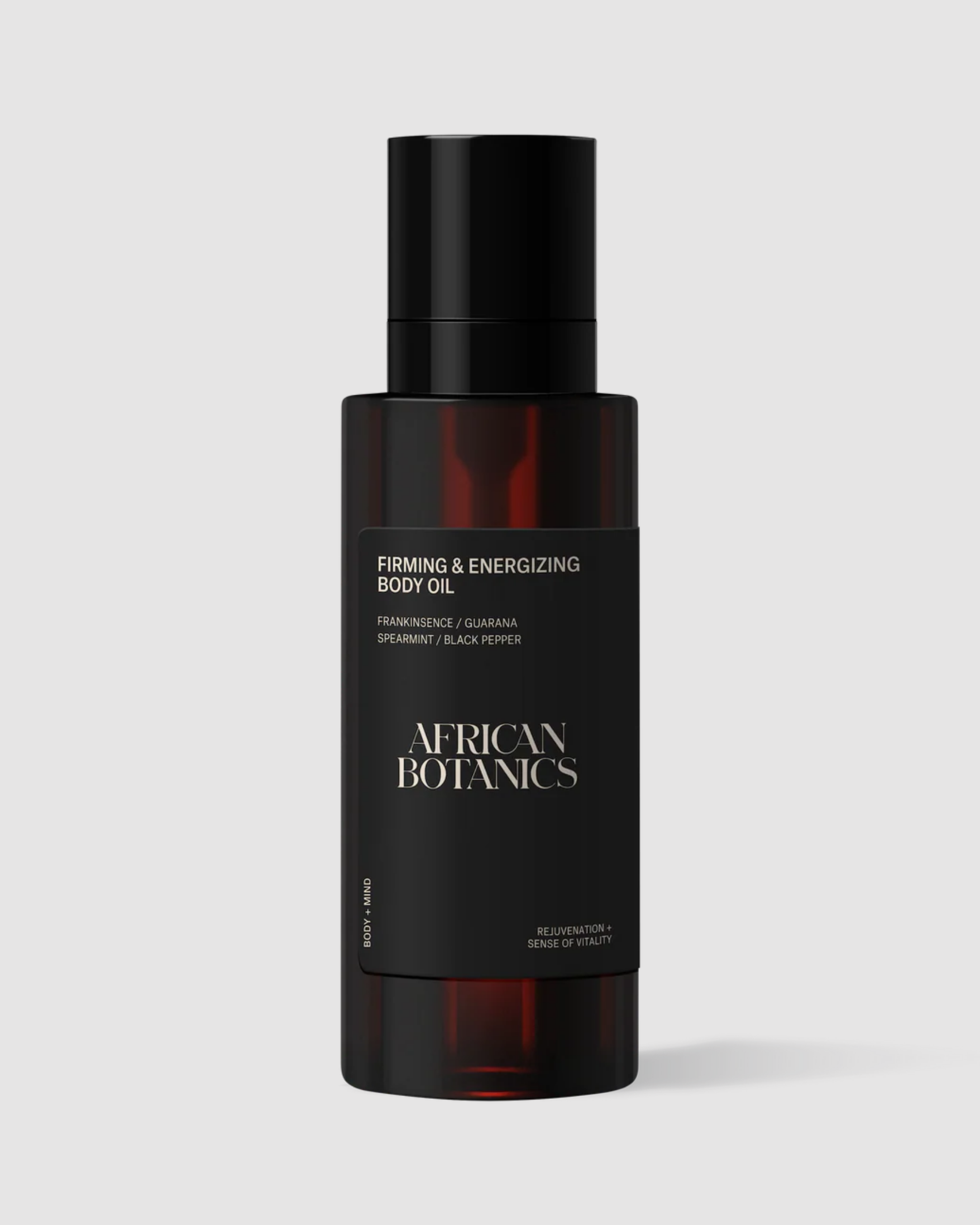 Black bottle of African Botanics firming and energizing body oil on a light gray background