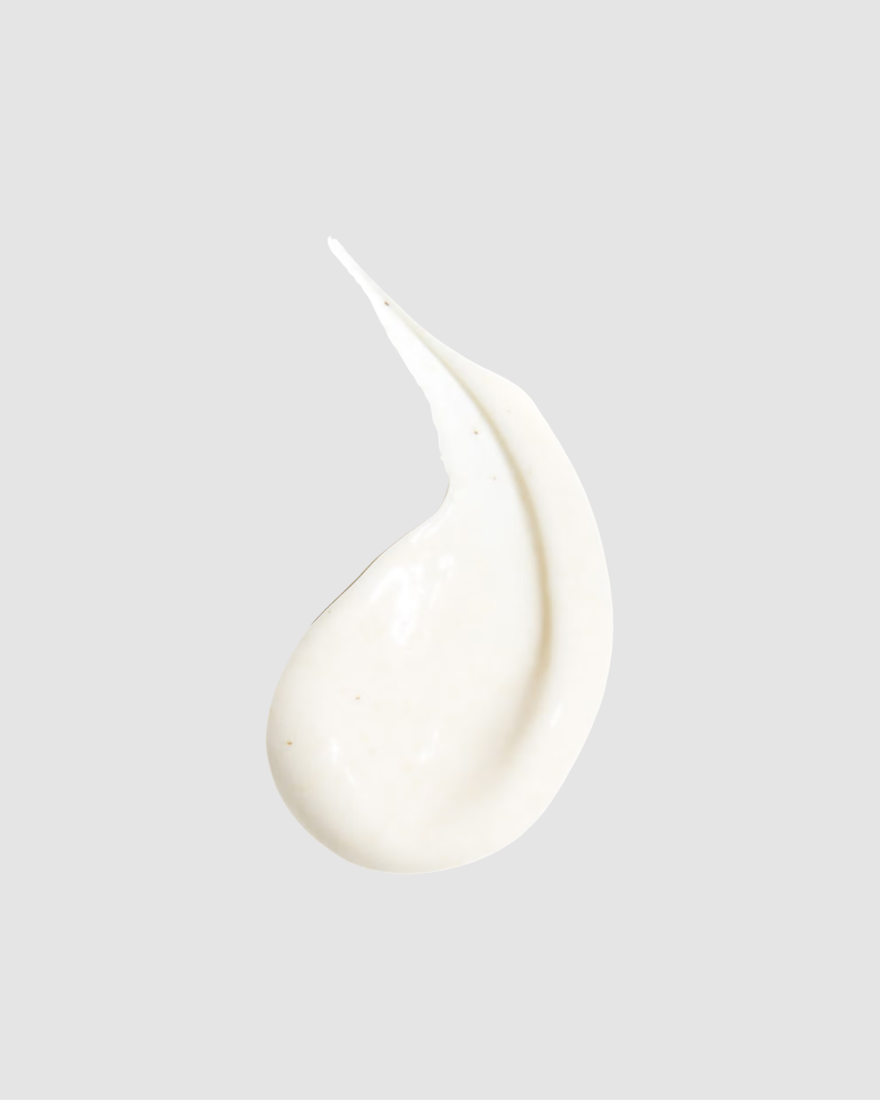 White cream droplet on a light gray background