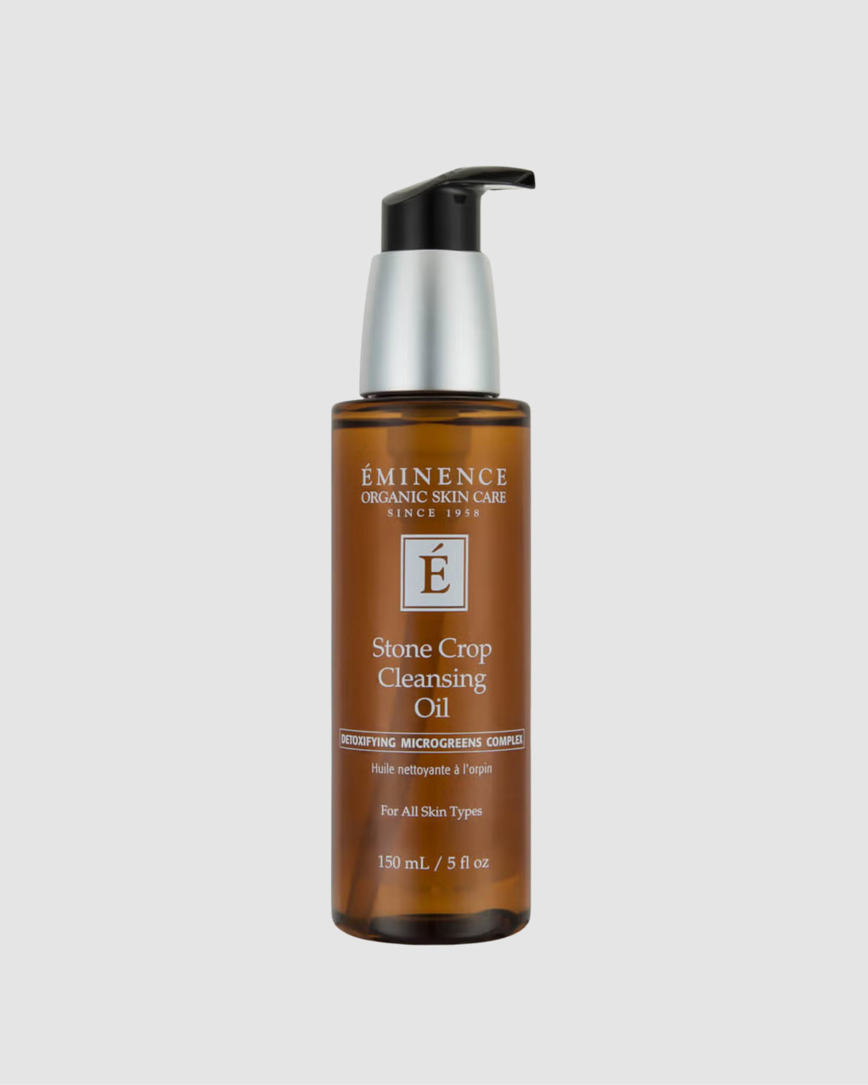 Bottle of Eminence Stone Crop Cleansing Oil on a light gray background