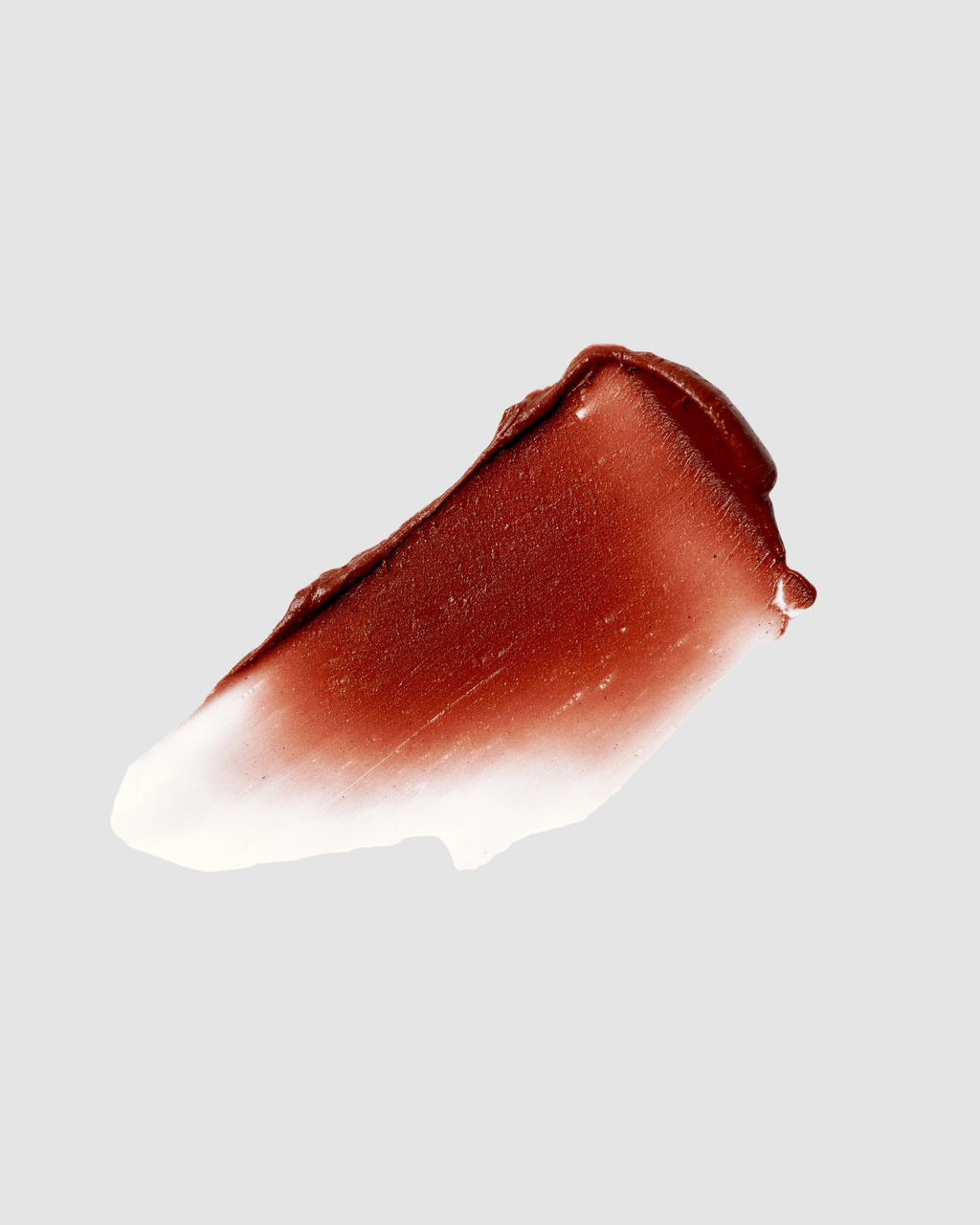 Brown lipstick swatch on a light gray background