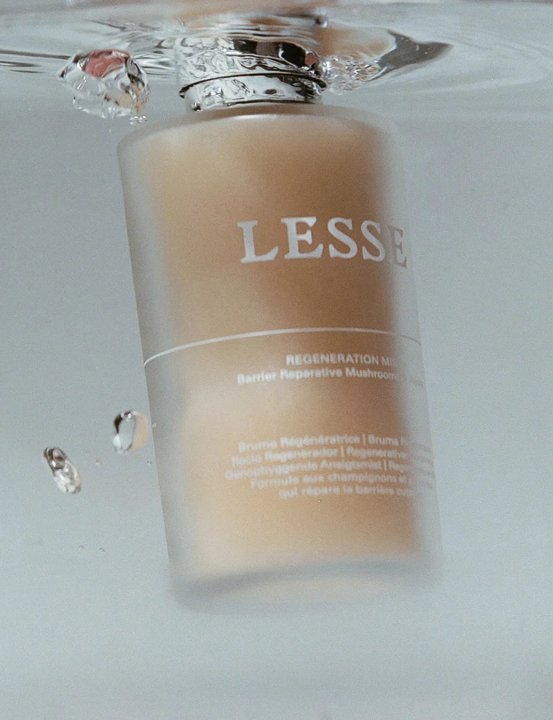 Cosmetic bottle with 'LESSE' branding on a reflective surface
