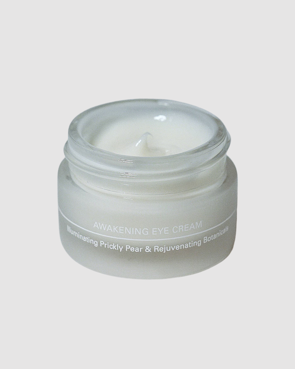 Jar of eye cream labeled 'Awakening Eye Cream' on a light gray background
