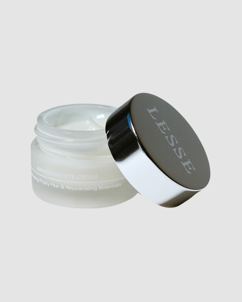 Skincare jar with 'LESSE' branding on a light gray background