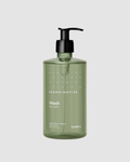 Green bottle of Skandinavisk Wash on a light gray background