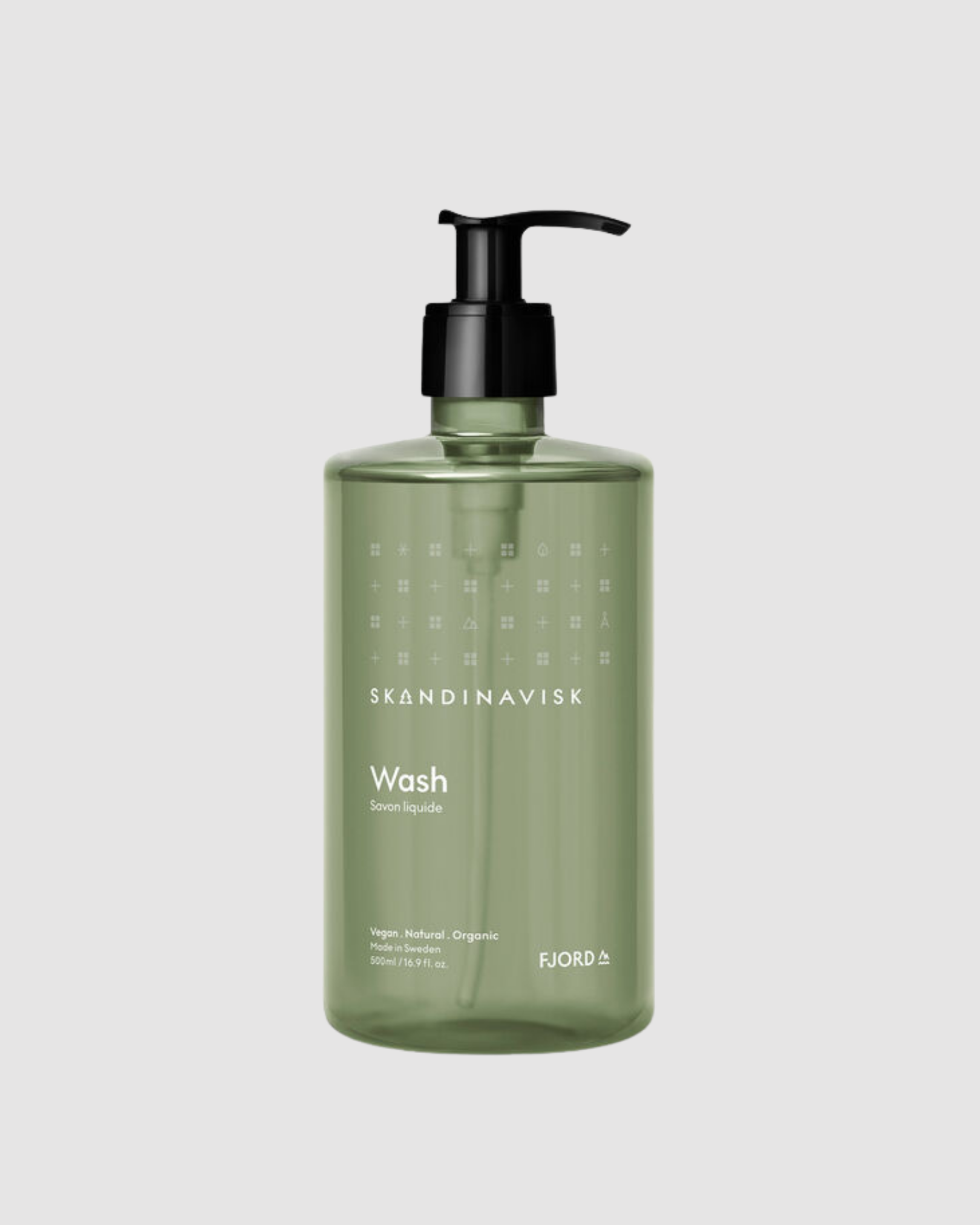 Green bottle of Skandinavisk Wash on a light gray background