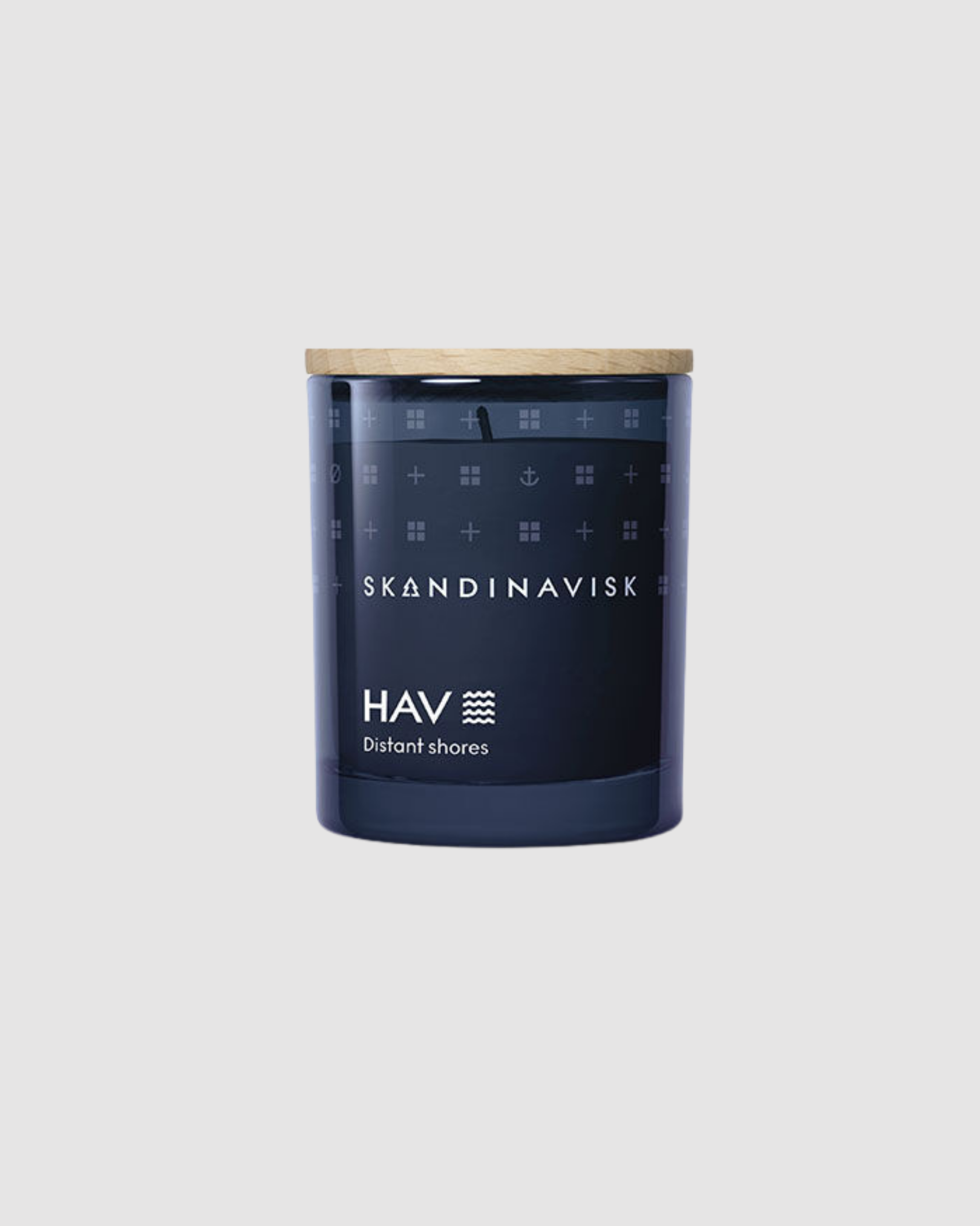 Navy candle jar with wooden lid featuring Skandinavisk branding on a light gray background