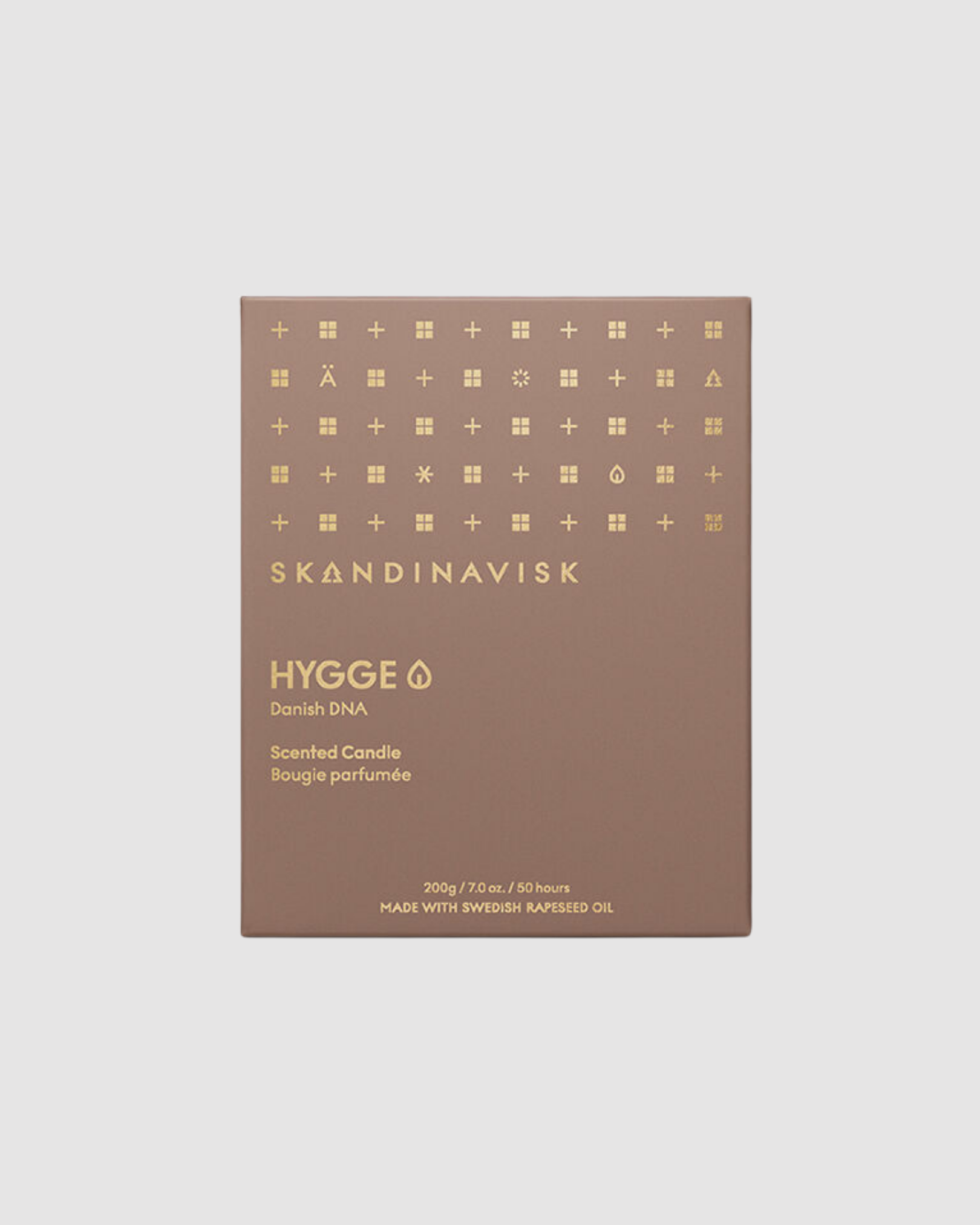 Skandinavisk candle packaging with gold symbols on a beige background