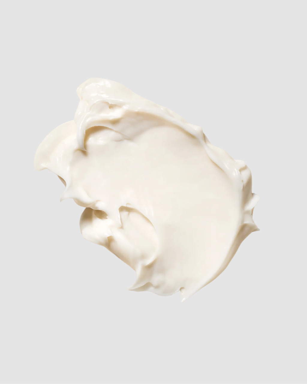 Swirl of white cream on a light gray background