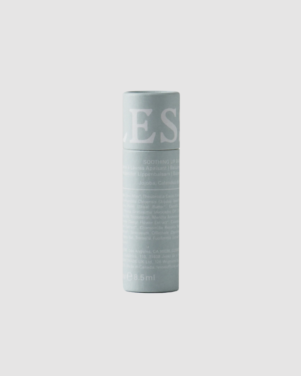 Light blue LESSE Lip Balm container with text on a light gray background