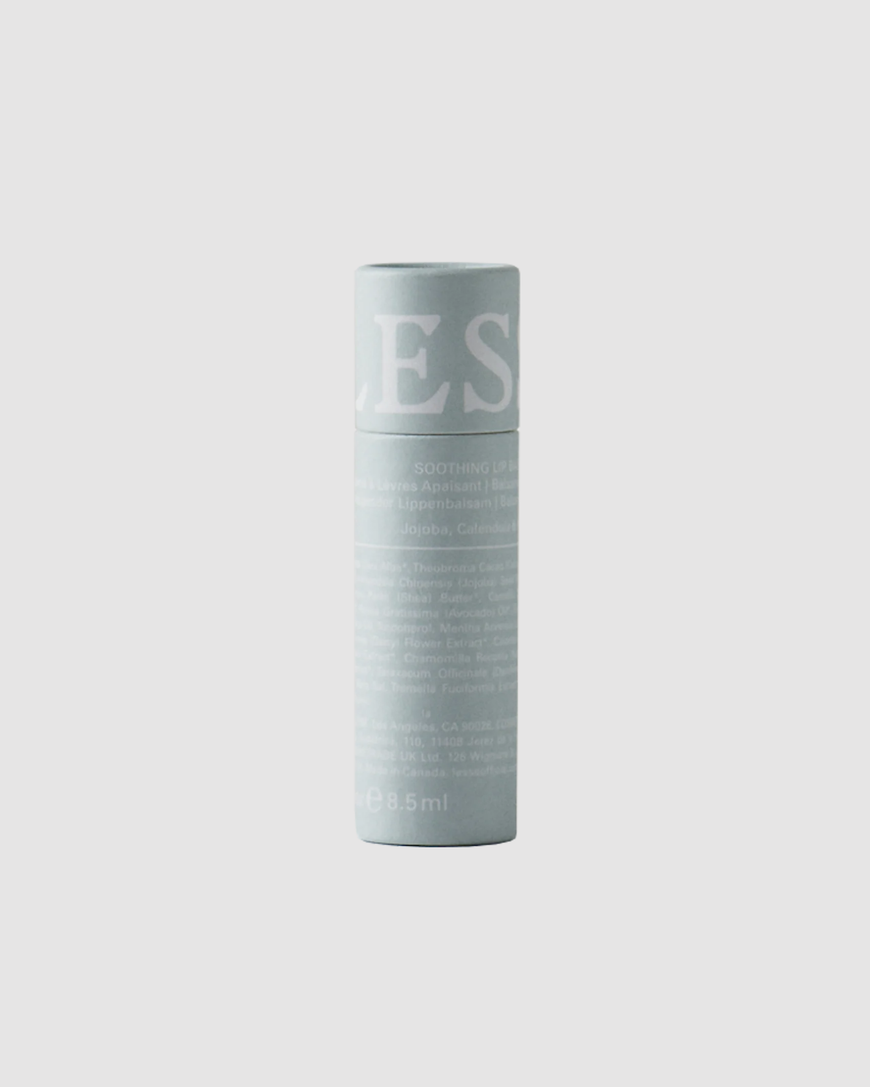 Light blue LESSE Lip Balm container with text on a light gray background