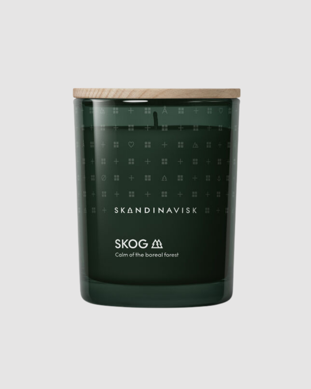 Skandinavisk candle with a dark green container and wooden lid on a light gray background