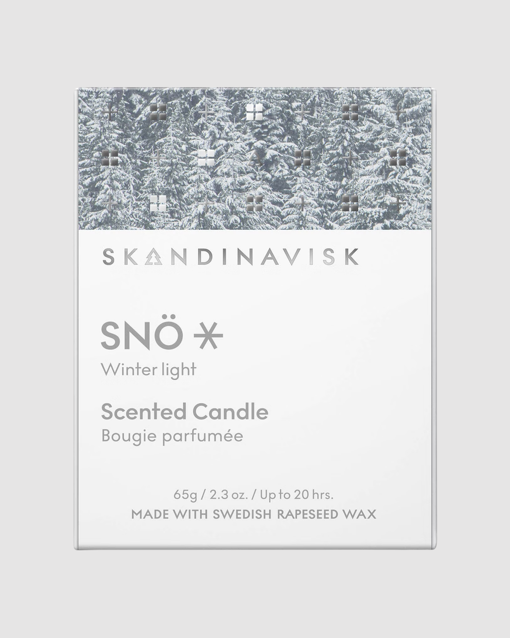 Skandinavisk Snö scented candle packaging with winter light design on a gray background