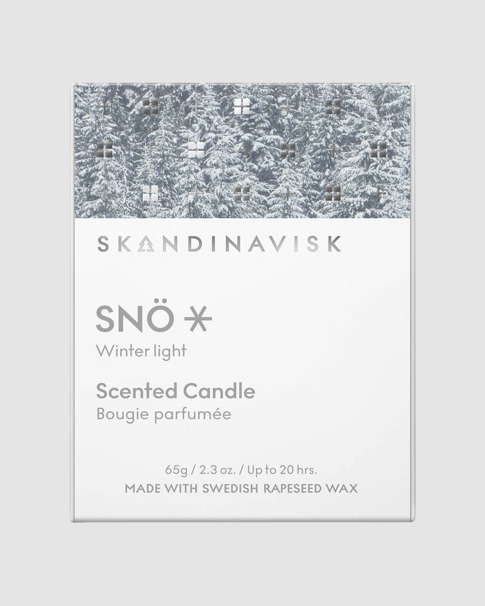 Skandinavisk Snö scented candle packaging with winter light design on a gray background