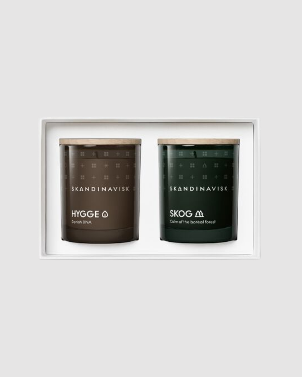 Two Scandinavian candles in a white frame on a light gray background