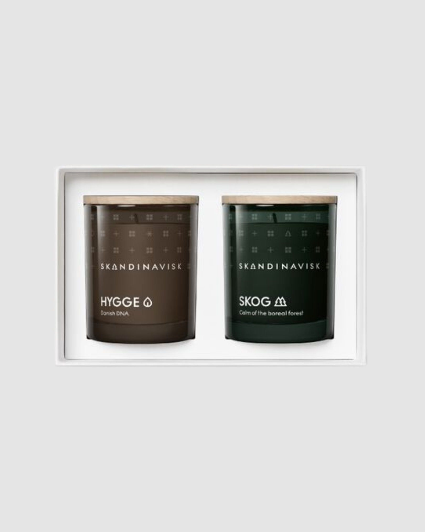 Two Scandinavian candles in a white frame on a light gray background